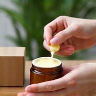 Image illustrating process step: Hands placing a product in sustainable packaging